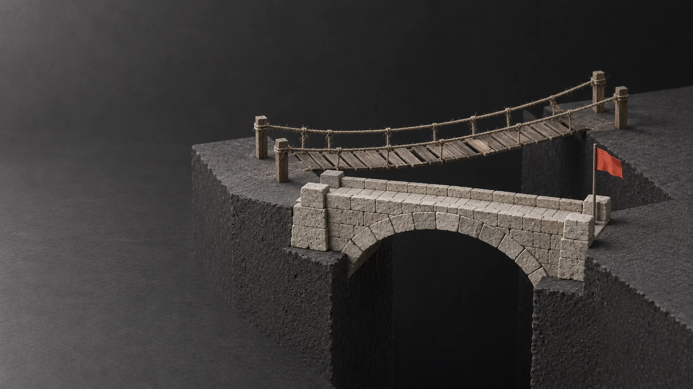 Two bridges over the same gap: a solid stone one and a hanging one made of rope and planks
