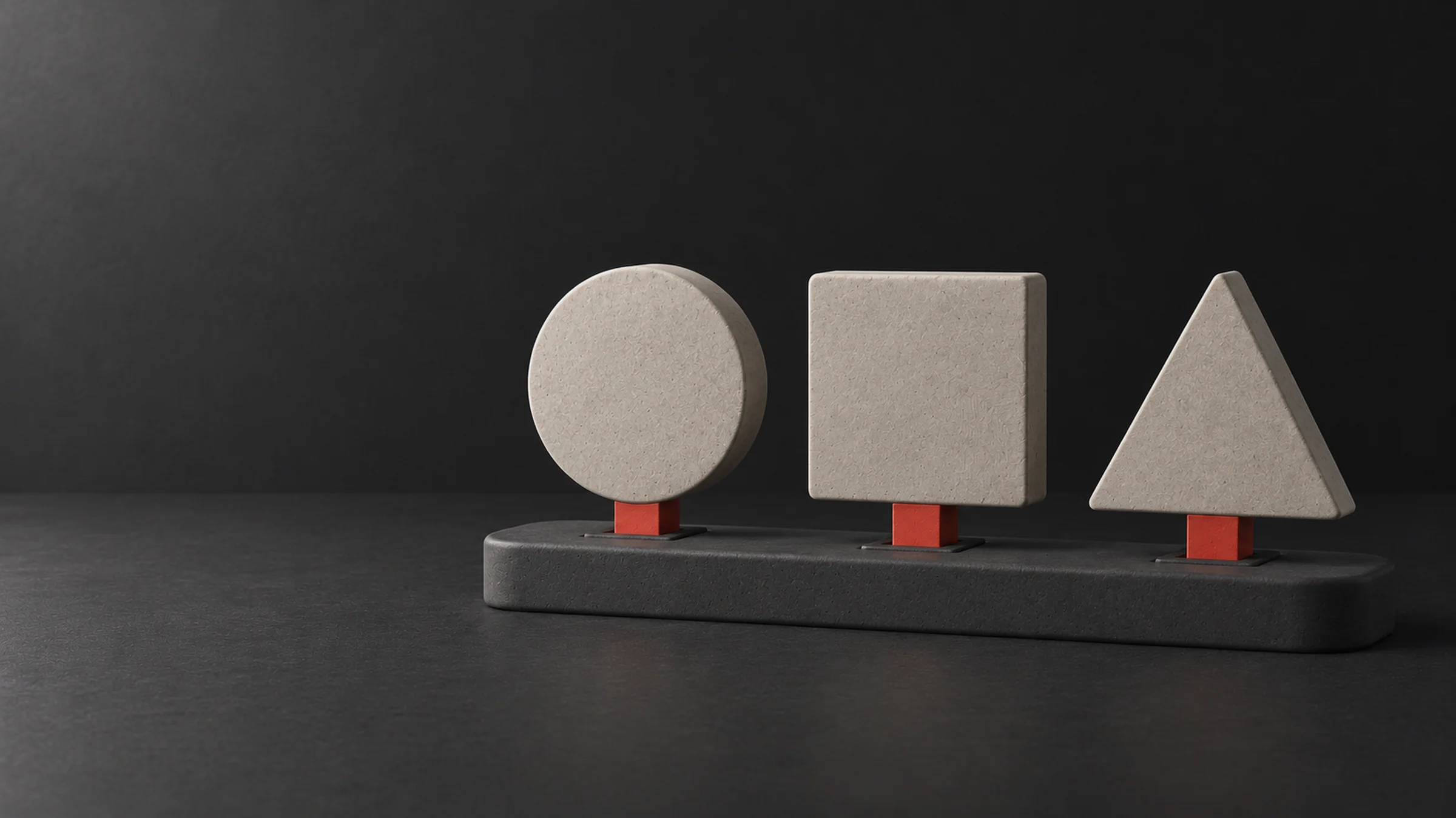 A circle, a square and a triangle fitted into the same base with identical red connectors